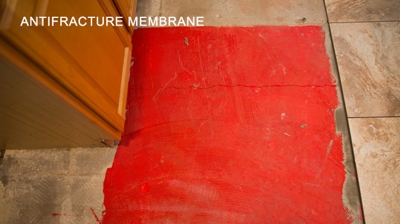 We always apply an anti-fracture membrane over cracks in the slab. Photo