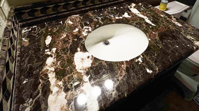 This image shows the restored and sealed marble vanity. Photo