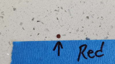 This BEFORE image shows one of many red flecks we removed. Photo