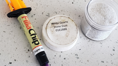 We used a premium professional custom-tinted filler to closely match the predominant color in the countertop. Photo