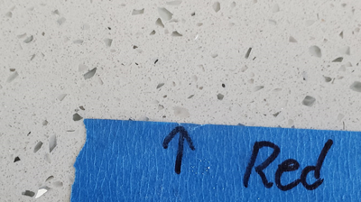 This AFTER image shows one of many red flecks we replaced with filler material. Photo