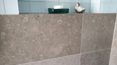 Here is another BEFORE image of the limestone shower. Photo