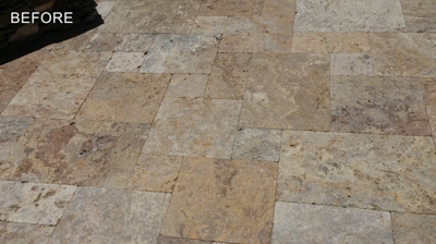 The porous surface of the travertine trapped dirt and grime. Photo