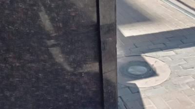 This AFTER image shows the granite veneer reattached. Photo