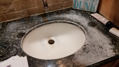 In this BEFORE image, the surface damage on this granite vanity is very obvious. Photo