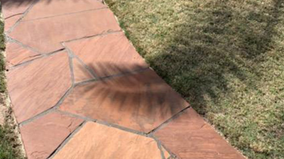 Here is the same walkway as the previous image AFTER we refinished the flagstone. Photo