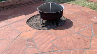 The fire pit area looks warm and welcoming AFTER our flagstone refinishing. Photo