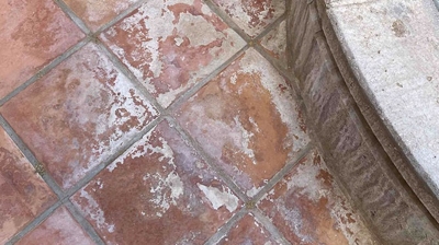 Here you can see the mineral deposits from water overspray on the tiles around the base of fountain. Photo