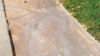 This BEFORE image shows the toll the intense Arizona sun takes on exterior stone. Photo