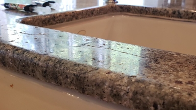 Here is the granite countertop BEFORE repair and restoration. Photo