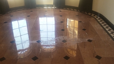 The etch damage in the middle of this granite and marble floor is evident. Photo