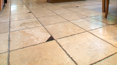 Notice how the textured edges of the chiseled travertine and the porous grout lines trapped dirt and grime. Photo