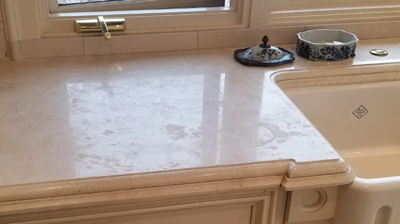 Notice the etch damage (commonly called “water marks”) near the sink. Photo