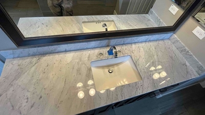 This AFTER image shows the like-new finish of the marble around the sink. Photo