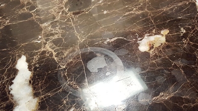 In this BEFORE image, notice the circular pattern, likely caused by a drink cup containing an acidic substance, such as wine or Photo