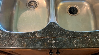This BEFORE image shows the cracked granite countertop. Photo