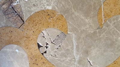 Notice the stone damage on this decorative floor medallion. Photo