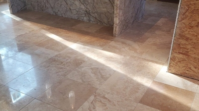 This BEFORE image shows the signs of wear from trades people passing through the area by the kitchen island. Photo