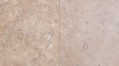 This BEFORE image shows the honed finish of these exterior travertine tops. Photo