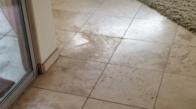 In this BEFORE image you can see that in some areas the travertine finish was badly damaged. Photo