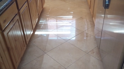 Here is an AFTER image of the kitchen floor, after we floated, honed, polished, and sealed the travertine. Photo