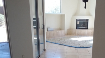 This AFTER image shows the grout lines repaired and the travertine finish restored. Photo