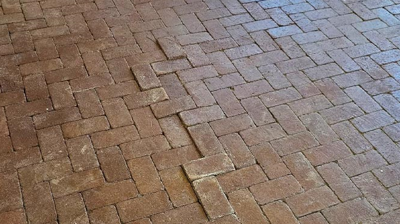 This image shows where the brick pavers had settled, creating an uneven surface. Photo
