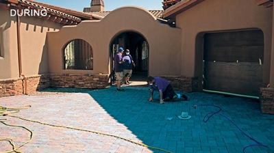 Here you can see our highly trained and skilled technicians stripping the old topical sealer from the concrete pavers. Photo