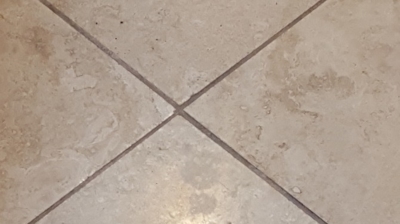 This BEFORE image shows how dark and dirty the grout lines looked before our travertine services. Photo