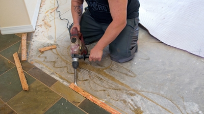 This image shows our highly trained technician performing tile removal services. Photo