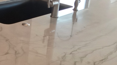 This BEFORE image shows dull spots near the plumbing fixtures. Photo