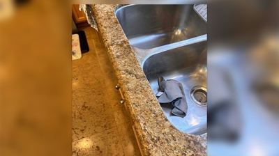 Here is the repaired granite countertop along the edge of the sink. Photo
