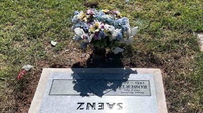 The headstone after restoration with nice flowers. Photo