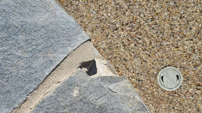 The flagstone was chipped and damaged in certain placed. Photo