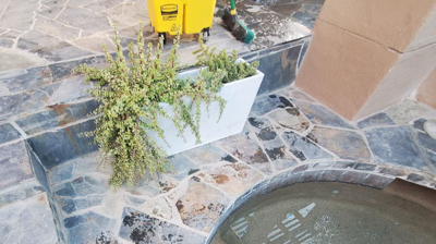 This BEFORE image shows the buildup of calcium deposits around the hot tub area. Photo