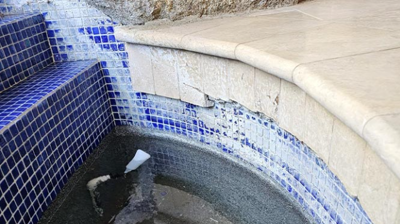 This BEFORE image shows damaged travertine tiles. Photo