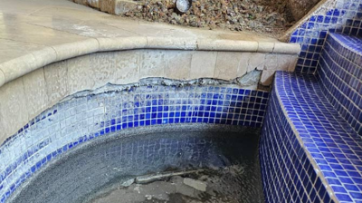 Here is another BEFORE image showing calcium deposits, as well as broken and missing tiles. Photo