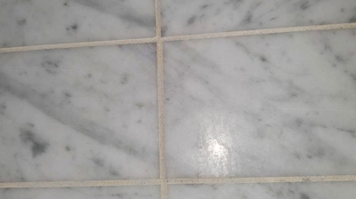 Here is a BEFORE image of the marble. Notice the etch marks on the surface. Photo
