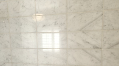 The marble shower tiles were restored to like new, as you can see in this AFTER image. Photo