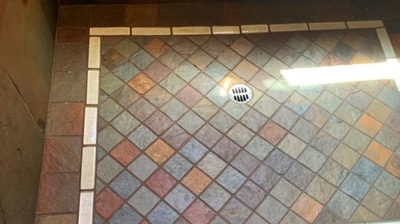 The slate shower floor looks clean and new in this AFTER image. Photo