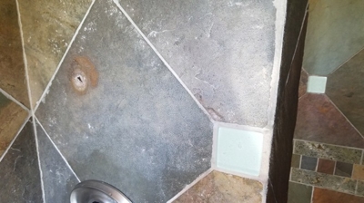 Here is a BEFORE image. Improper topical sealer ruined the finish of this slate shower. Photo
