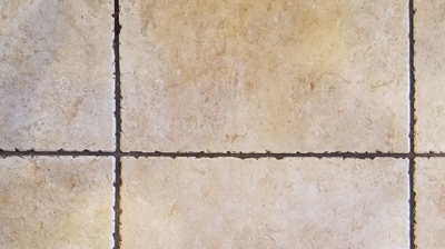 This BEFORE image shows a close up of the dark, dirty grout lines. Photo