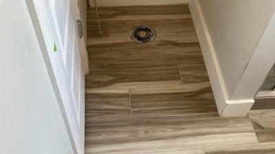 Here is an AFTER image showing the new floor tiles in the same bathroom. Photo