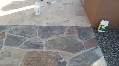 This BEFORE image shows the dull-looking travertine and flagstone. Photo