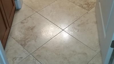 Here is a closer look at the damaged travertine finish. Photo