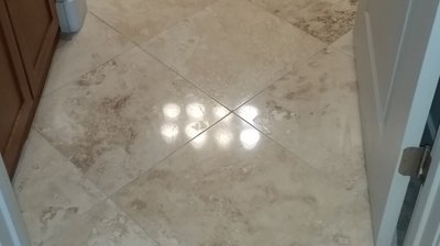 This is the same section of the floor, but after honing and polishing, you can see the individual overhead lights. Photo