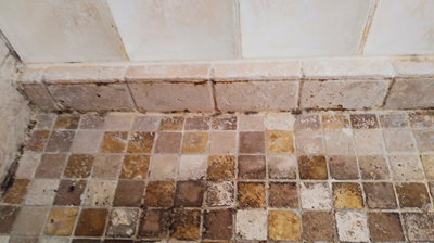 Here is a close up of the travertine shower pan before we did any work. Photo