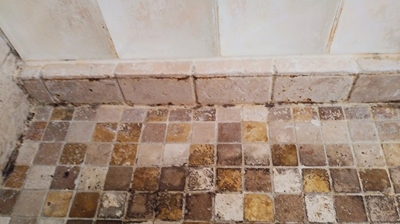 Here is a close up of the travertine shower pan before we did any work. Photo