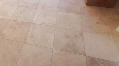 Notice the unsightly, dull travertine finish in this BEFORE image. Photo