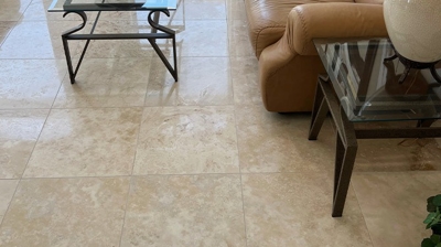 In this BEFORE image, the travertine floor has reflection under the coffee table but the walking areas look dull. Photo